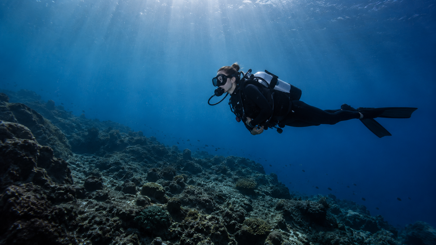 Two divers communicating underwater with hand signals